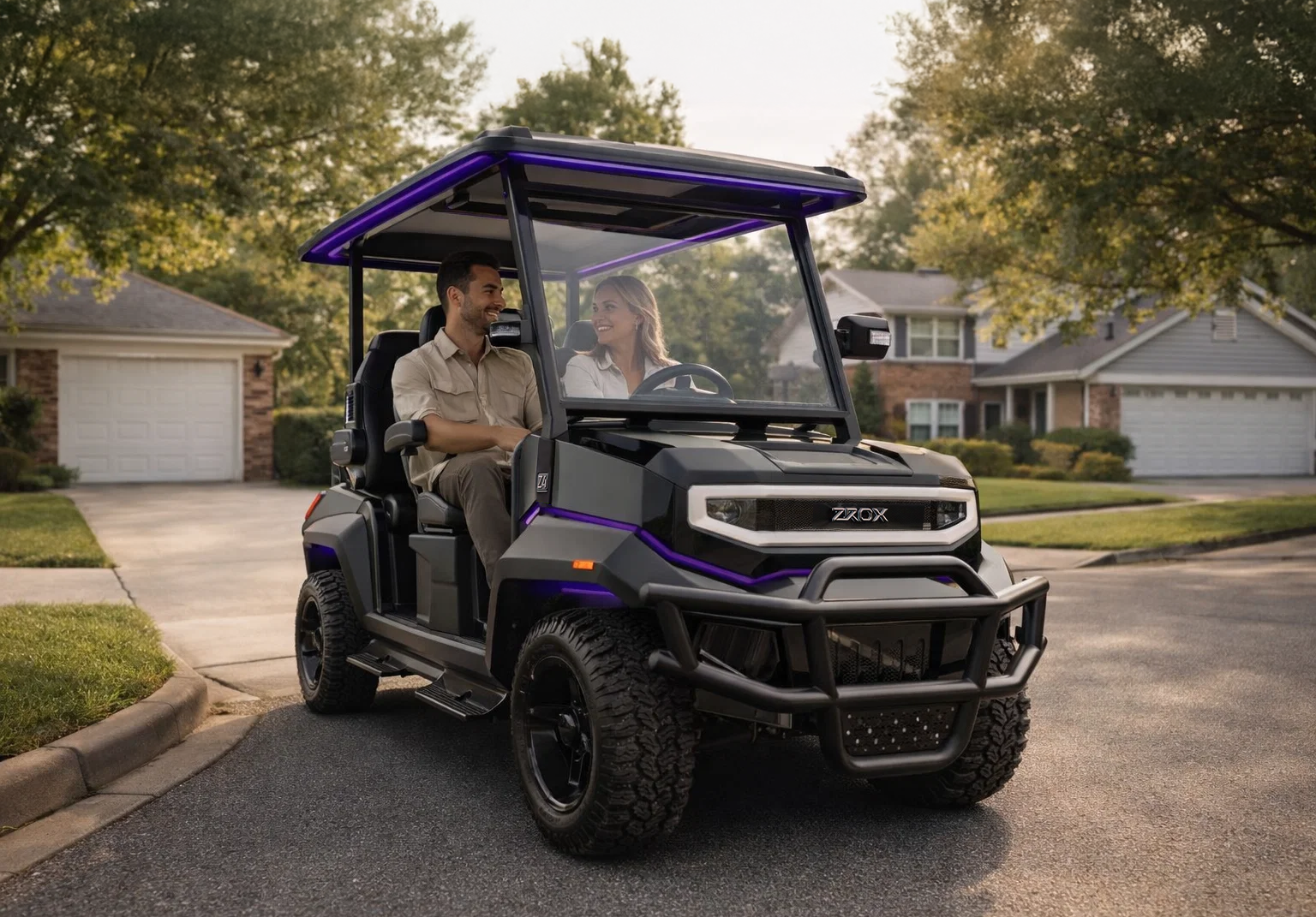Two people riding in a black and purple golf cart on a residential street.